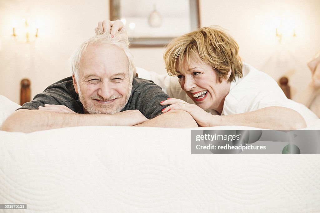 Couple lying on bed, portrait