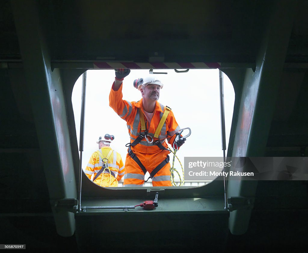 Civil engineers inspecting structure under carriageway of suspension bridge. The Humber Bridge, UK, built in 1981 was the world's largest single-span suspension bridge