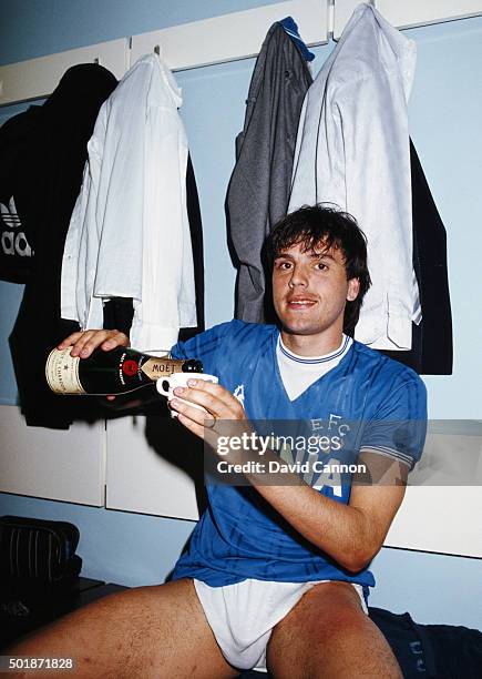 Everton striker Graeme Sharp pours himself a mug of champagne in the dressing room after the Canon League Division One match against West Ham United...