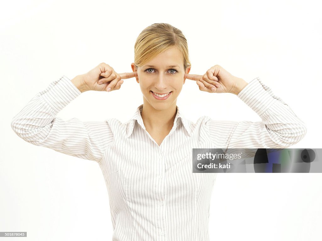 Young woman holding her fingers in her ears