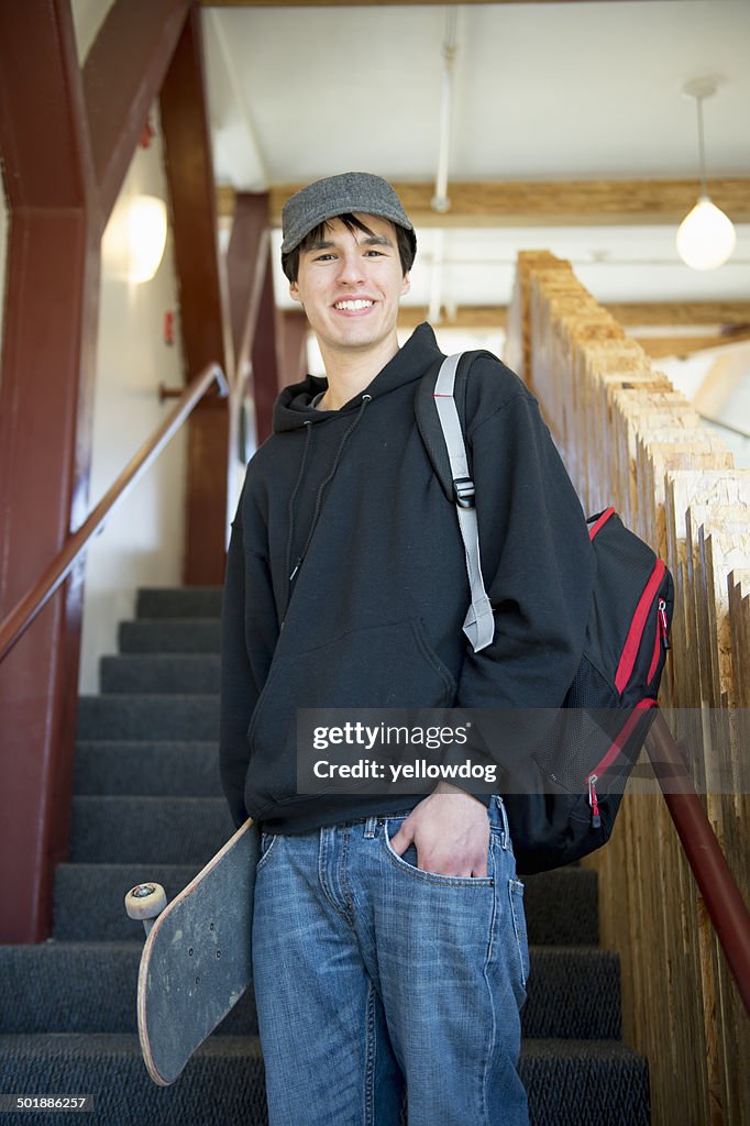 Student on staircase with skateboard