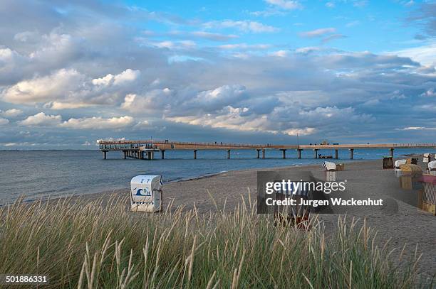 beach with the pier, erlebnis-seebruecke, heiligenhafen, baltic sea, schleswig-holstein, germany, europe - erlebnis stock pictures, royalty-free photos & images