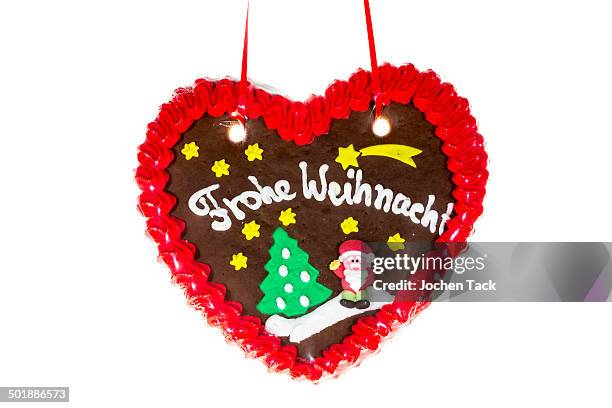 gingerbread heart with the writing frohe weihnachten, german for merry christmas - frohe weihnachten fotografías e imágenes de stock