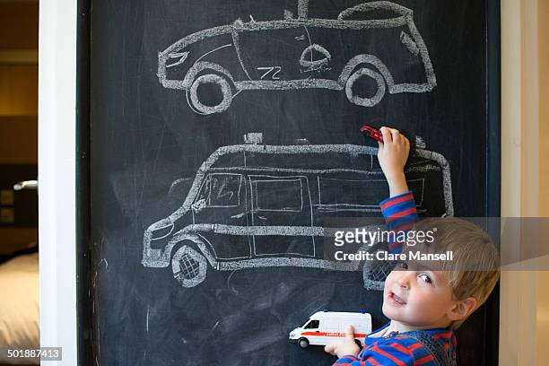 blackboard - boy playing with cars stock pictures, royalty-free photos & images