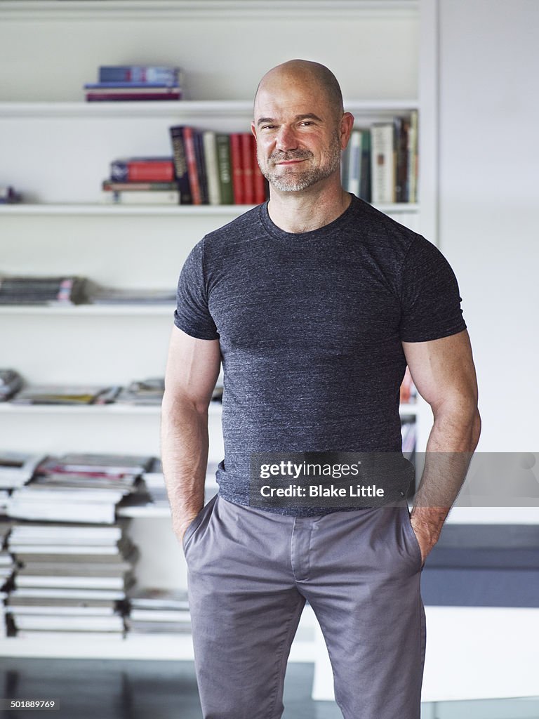 Man standing in front of bookshelf