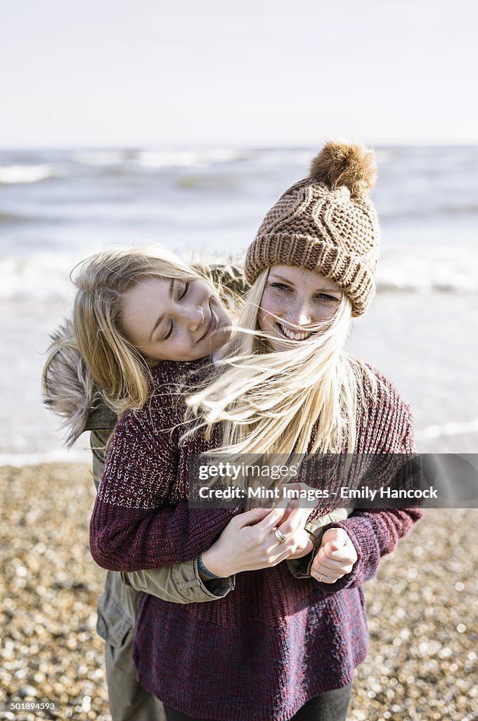 Two girls on the beach in winter.