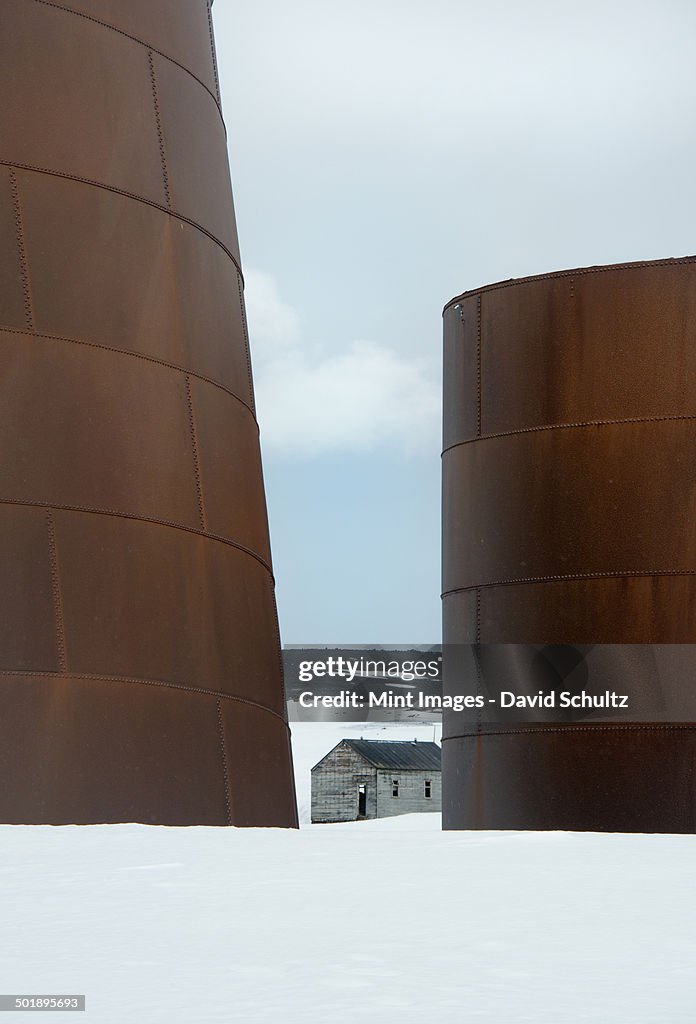 Tall rusting metal whale oil tanks at the former whaling station on Deception Island.