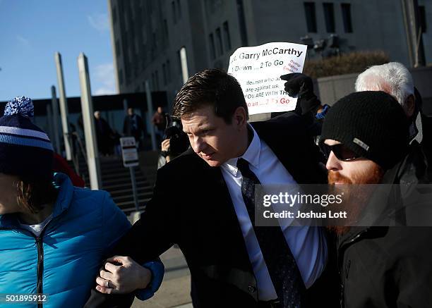 Former Chicago police officer Jason Van Dyke, center, who was charged with murder last month in the shooting death of Laquan McDonald leaves the Cook...