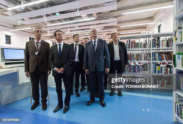 French Prime Minister Manuel Valls stands next to Socialist Party president of the Grand Angouleme cosmopolitan area Jean-Francois Daure , mayor of...