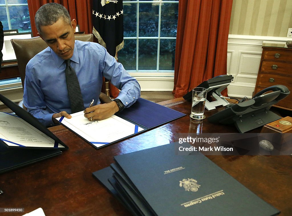 President Obama Signs Bills In The Oval Office Of White House