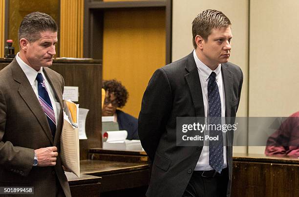 Chicago police Officer Jason Van Dyke, right, leaves the courtroom after a hearing with his attorney Daniel Herbert at Leighton Criminal Court...