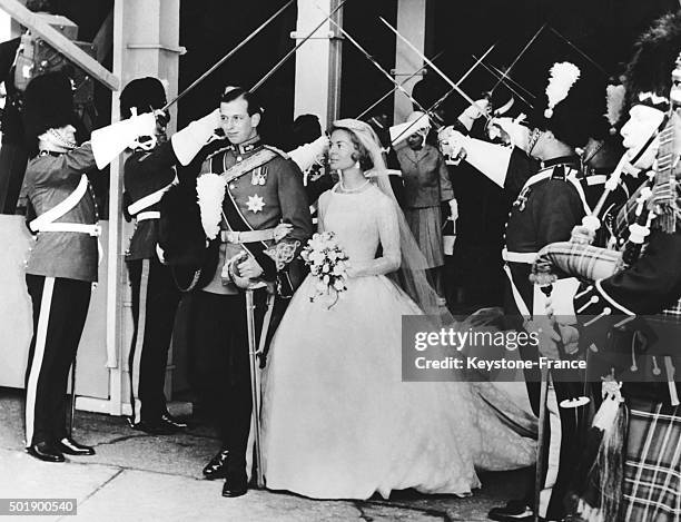 Duke of Kent with Katharine Worsley after the ceremony under the archway of swords held by officers of the regiment of the groom at York Minster on...