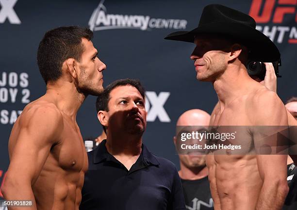 Opponents Rafael dos Anjos of Brazil and Donald 'Cowboy' Cerrone face off during the UFC weigh-in at the Orange County Convention Center on December...