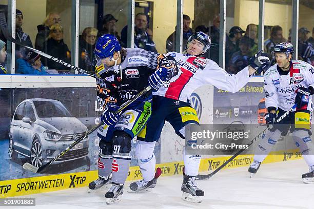 Rene Roethke of Straubing Tigers handles the puck against Marcel Noebels of the Eisbaeren Berlin during the game between the Straubing Tigers and the...