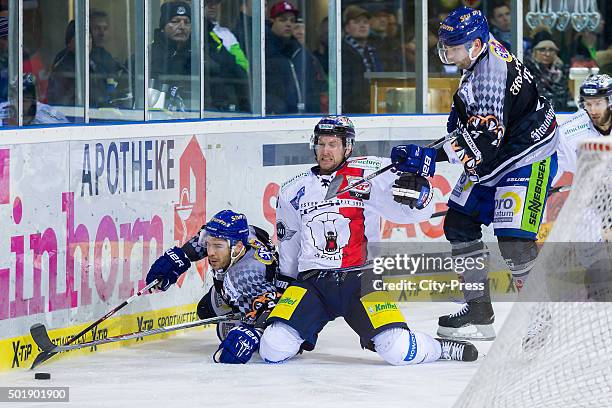Sebastian Osterloh of Straubing Tigers and Mark Olver of the Eisbaeren Berlin fight for the puck during the game between the Straubing Tigers and the...