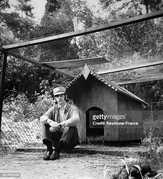 Ringo Starr maybe on guard close to the dog house on the garden of his house in Weybridge, United Kingdom, circa 1960.