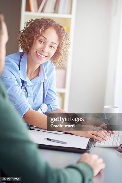 happy female doctor with patient - general practitioner stock pictures, royalty-free photos & images