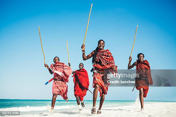 masai people running on the beach.jpg - masai stock pictures, royalty-free photos & images