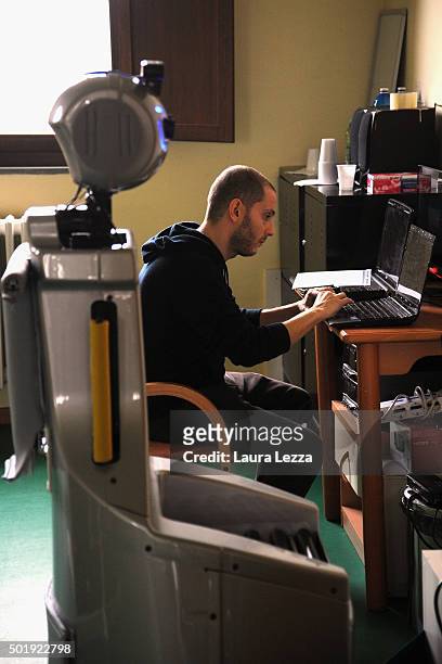 Assistant researcher of the Scuola Superiore Sant'Anna di Pisa Raffaele Esposito controls a robot of the project Robot-Era at nursing residence San...