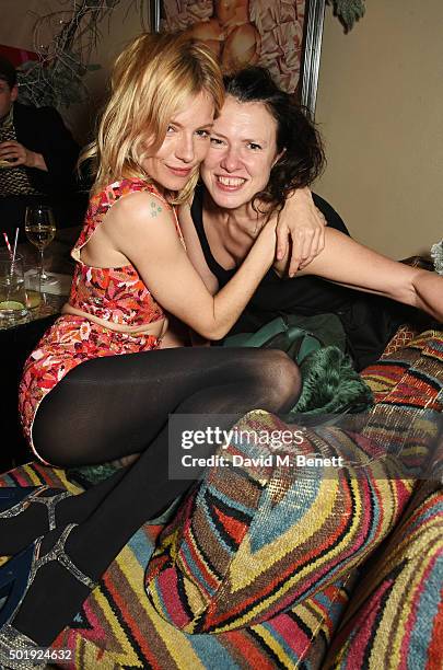 Sienna Miller and Katie Grand attend the LOVE Christmas party at George on December 18, 2015 in London, England.