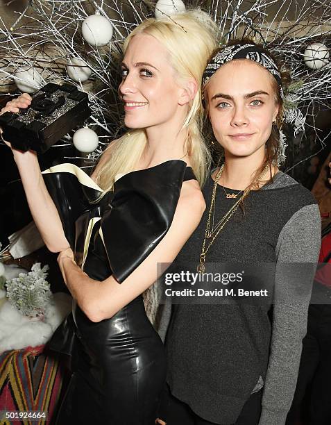 Poppy Delevingne and Cara Delevingne attend the LOVE Christmas party at George on December 18, 2015 in London, England.