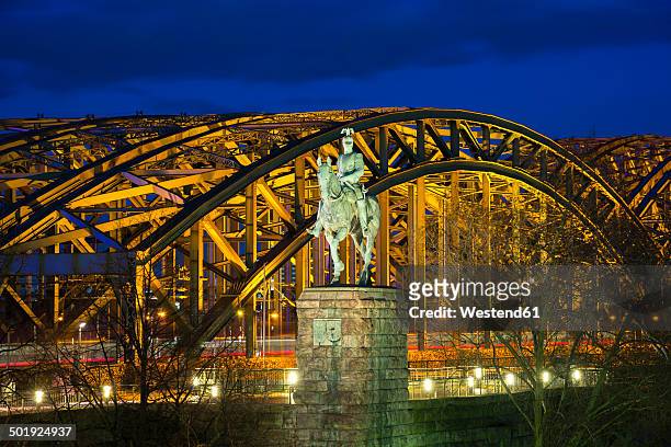 germnay, north rhine-westphalia, cologne, equestrian statue of emperor wilhelm ii in front of lighted hohenzollern bridge by night - memorial kaiser wilhelm stock pictures, royalty-free photos & images