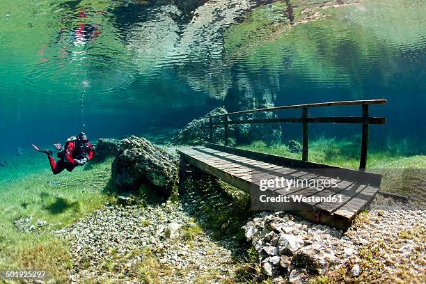 austria, styra, tragoess, green lake, diver and wooden boardwalk - styrka stock pictures, royalty-free photos & images