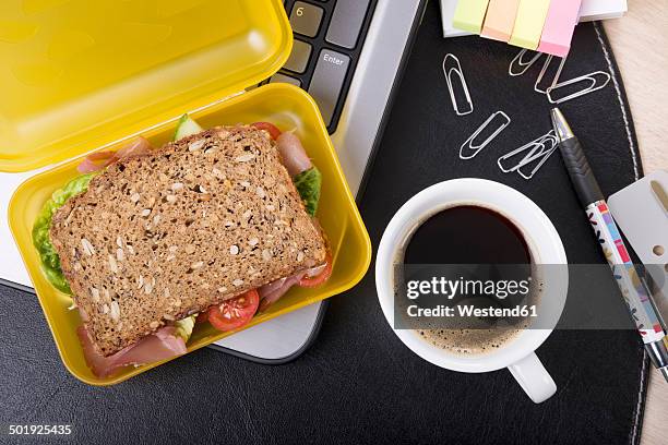 workplace with lunchbox and cup of coffee - granary stock pictures, royalty-free photos & images