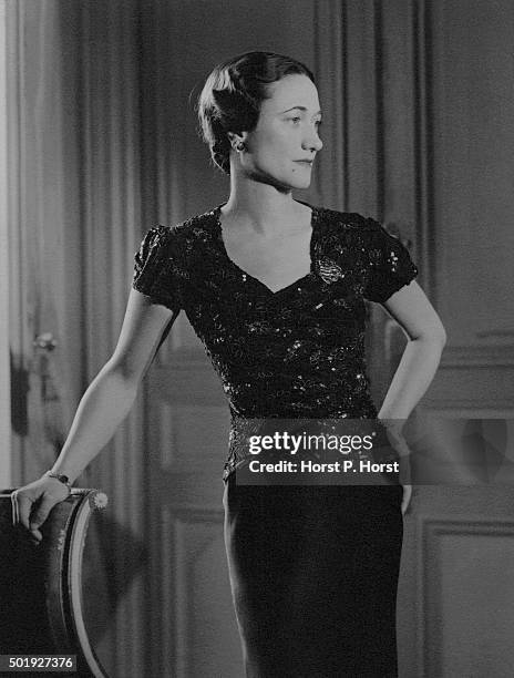 Duchess of Windsor, wearing a dress with brocade bodice, in her suite at the Hotel Meurice in Paris.