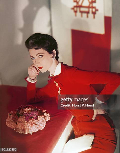 Model wearing a red velvet dress, silk lining by Harvey Berin and the diamonds by VanCleef & Arpels.