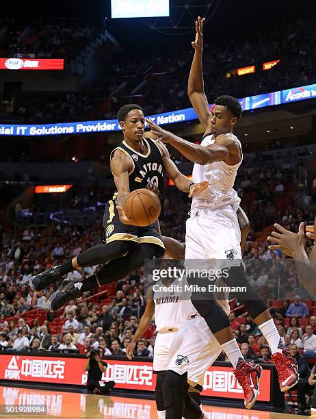 DeMar DeRozan of the Toronto Raptors passes away from Hassan Whiteside of the Miami Heat during a game at American Airlines Arena on December 18,...