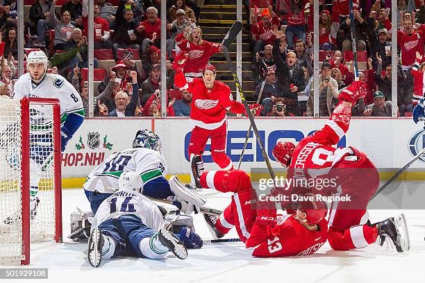 Joakim Andersson of the Detroit Red Wings celebrates his goal with teammates Pavel Datsyuk and Danny DeKeyser in front of goaltender Ryan Miller of...