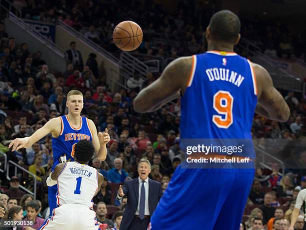 Kristaps Porzingis of the New York Knicks passes the ball over Tony Wroten of the Philadelphia 76ers to teammate Kyle O'Quinn on December 18, 2015 at...