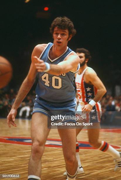 John Gianelli of the Buffalo Braves passes the ball against the New Jersey Nets during an NBA basketball game circa 1977 at the Rutgers Athletic...