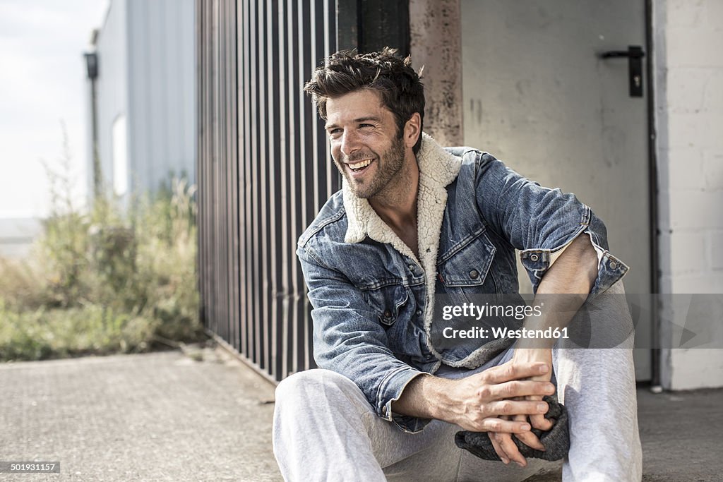 Portrait of laughing man wearing denim jacket