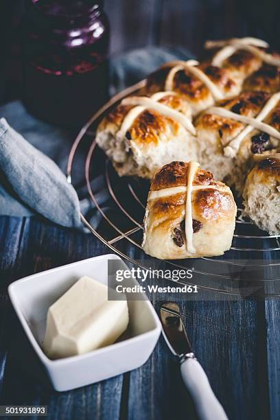 hot-cross-buns with raisins, blackcurrant jelly and butter - hot cross bun stock pictures, royalty-free photos & images