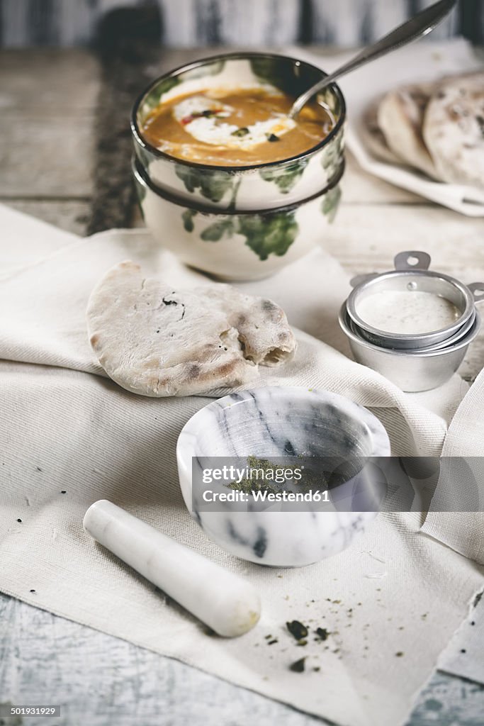 Spicy carrot soup with naan bread and pistachio yoghurt