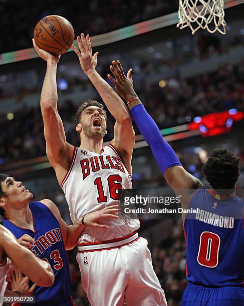 Pau Gasol of the Chicago Bulls shoots between Ersan Ilyasova and Andre Drummond of the Detroit Pistons at the United Center on December 18, 2015 in...