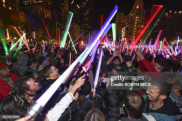 Star Wars fans raise their lightsabers during Lightsaber Battle LA in Pershing Square in downtown Los Angeles, California on December 18, 2015. "Star...