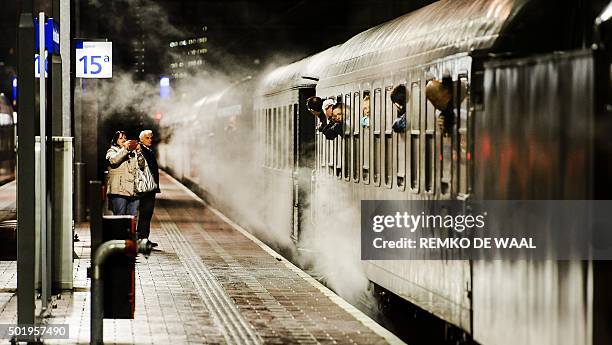 People are in a steam locomotive at the Rotterdam's train station on 19 December as they go to Christmas fairs in Maastricht and Valkenburg. / AFP /...