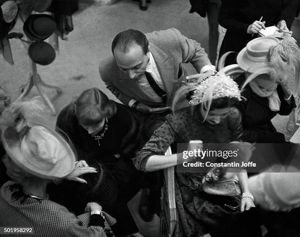 In Mr. John, Inc., hat salon: Milliner Mr. John and in foreground, Mrs. Clyde Newhouse; left, Mrs. Rouben Mamoulian; far left, Mrs. Cobina Wright.