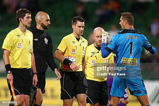 Ante Covic of the Glory questions Referee Jarred Gillett as players and officials walk from the field at the half time break during the round 11...