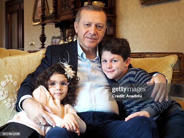 Turkish President Recep Tayyip Erdogan poses for famous Istanbul-based photojournalist Ara Guler with his grandson Ahmet Akif and granddaughter...