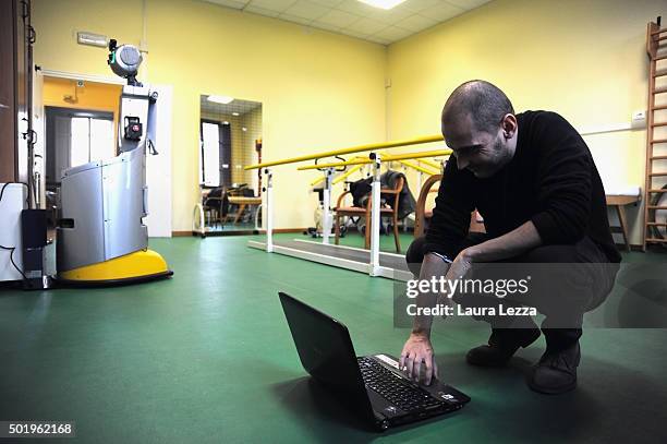 Assistant researcher of the Scuola Superiore Sant'Anna di Pisa Raffaele Esposito controls a robot of the project Robot-Era while charging at nursing...