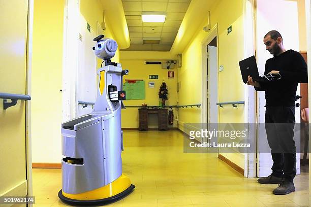 Assistant researcher of the Scuola Superiore Sant'Anna di Pisa Raffaele Esposito controls a robot of the project Robot-Era at nursing residence San...