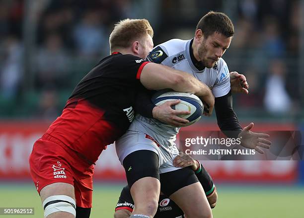 Oyonnax's full back from France Florian Denos is tackled by Saracens' flanker from England Jackson Wray and Saracens' scrum-half from South Africa...