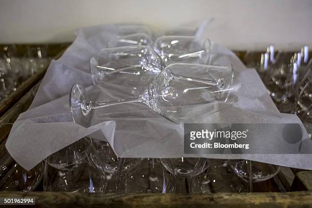 Hand crafted stemmed wine glasses sit in a wooden crate before polishing at the Novosad & Son Glassworks in Harrachov, Czech Republic, on Friday,...