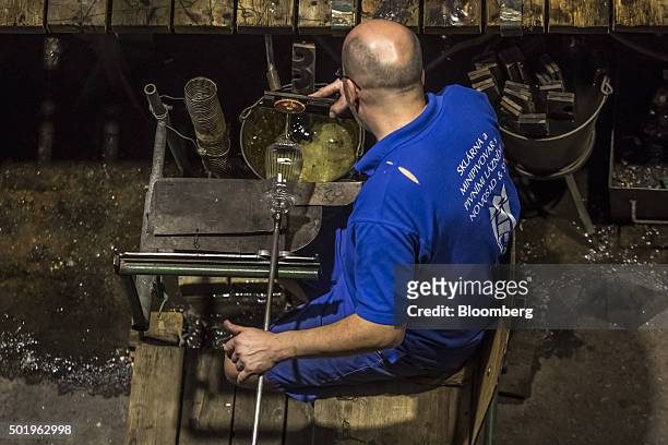 Glass maker shapes the footplate for a stemmed wine glass at the Novosad & Son Glassworks in Harrachov, Czech Republic, on Friday, Dec. 18, 2015....