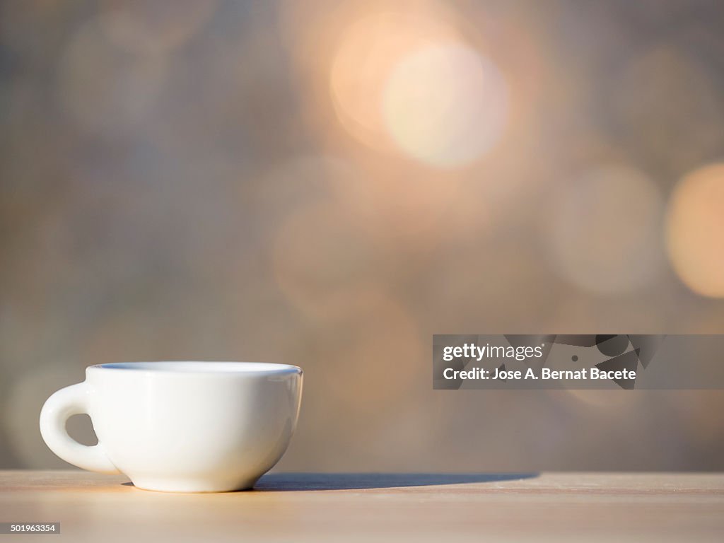 Cup of coffee on a table of wood outdoors