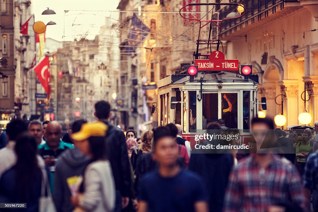 Historic red tram on crowded Istiklal Avenue in Taksim, Istanbul